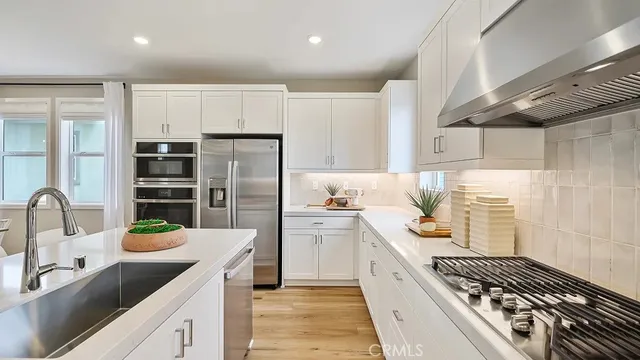 a kitchen with a refrigerator and a sink