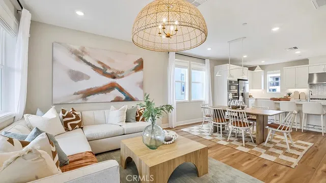 a living room with furniture a rug and a chandelier