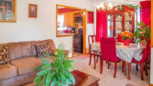 a living room with furniture and flowers