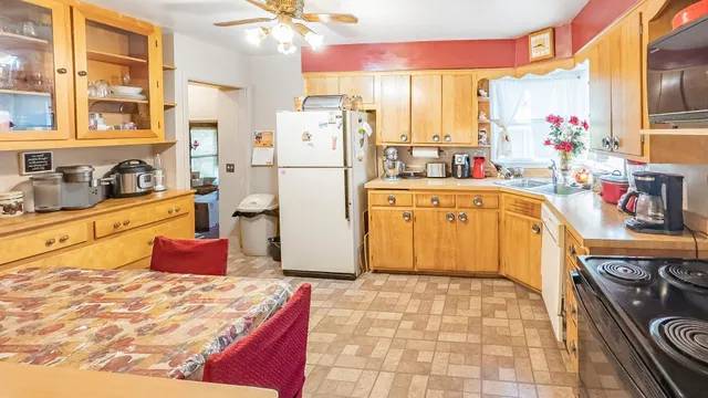 a kitchen with a refrigerator and stove