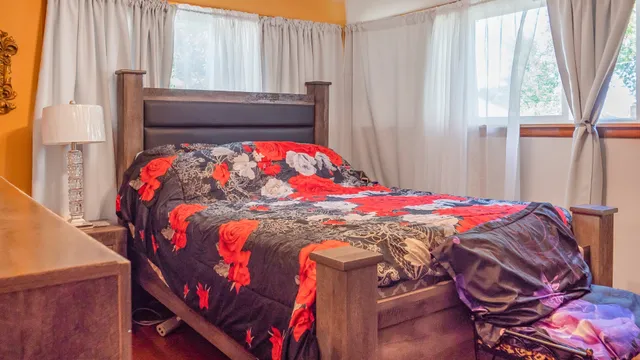 a bedroom with a bed and a window