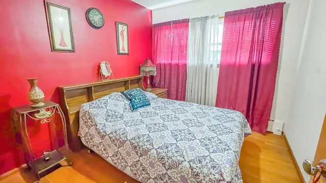 a bed sitting in a bedroom next to a window