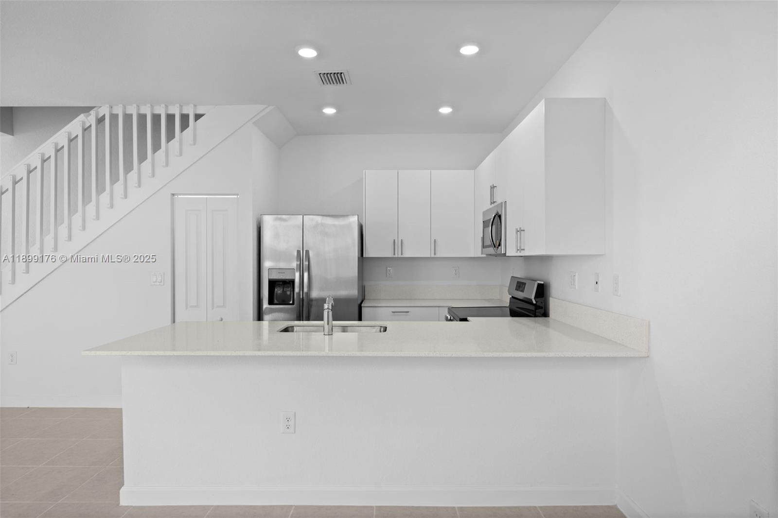 715 Southeast 15th Street Homestead, FL 33034 - Photo 12 of 33 a view of kitchen with stainless steel appliances granite countertop white cabinets and refrigerator