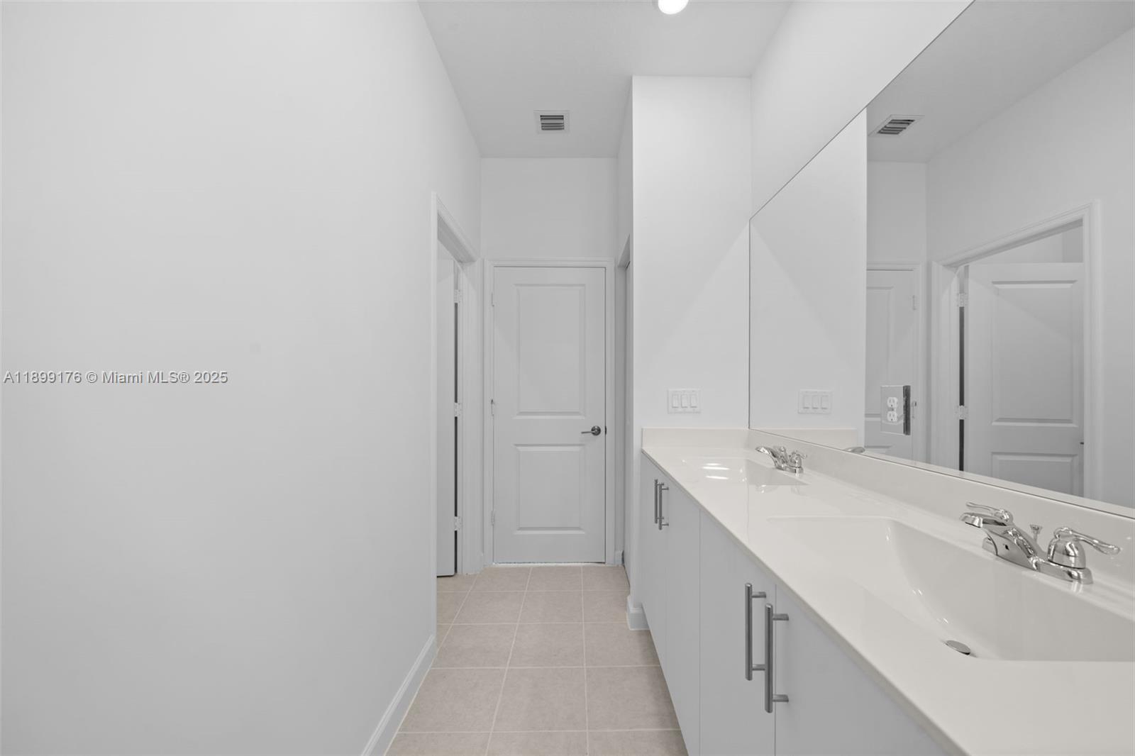 715 Southeast 15th Street Homestead, FL 33034 - Photo 23 of 33 a bathroom with a double vanity sink and mirror