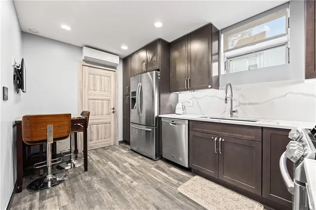 a kitchen with refrigerator and chair