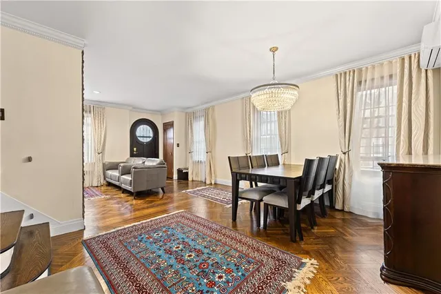 a view of a a dining room with furniture window and wooden floor
