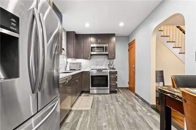 a kitchen with stainless steel appliances a refrigerator sink and stove