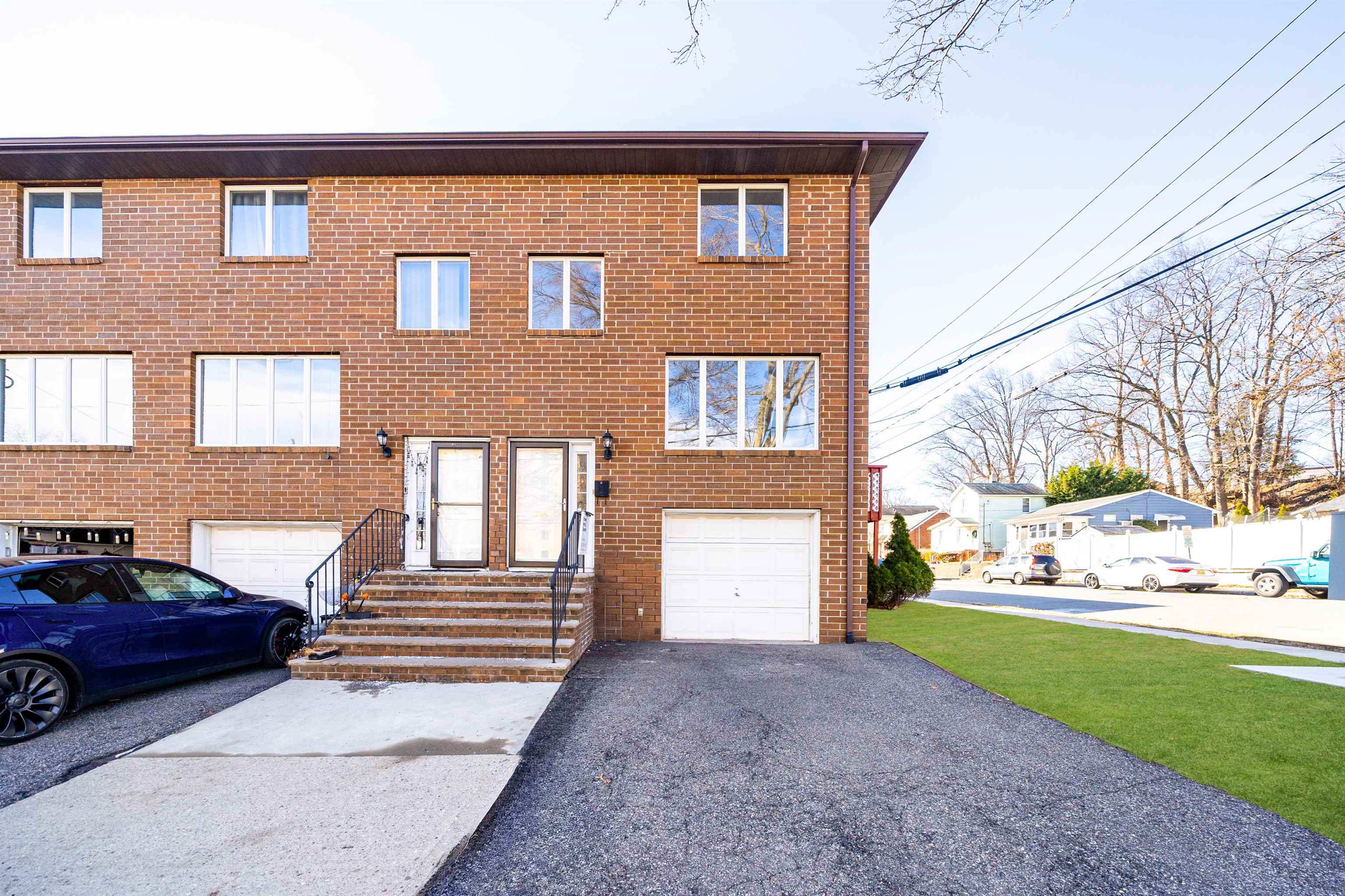 156 Main Street East Rutherford, NJ 07073 - Photo 1 of 19 a front view of a house with a yard and garage