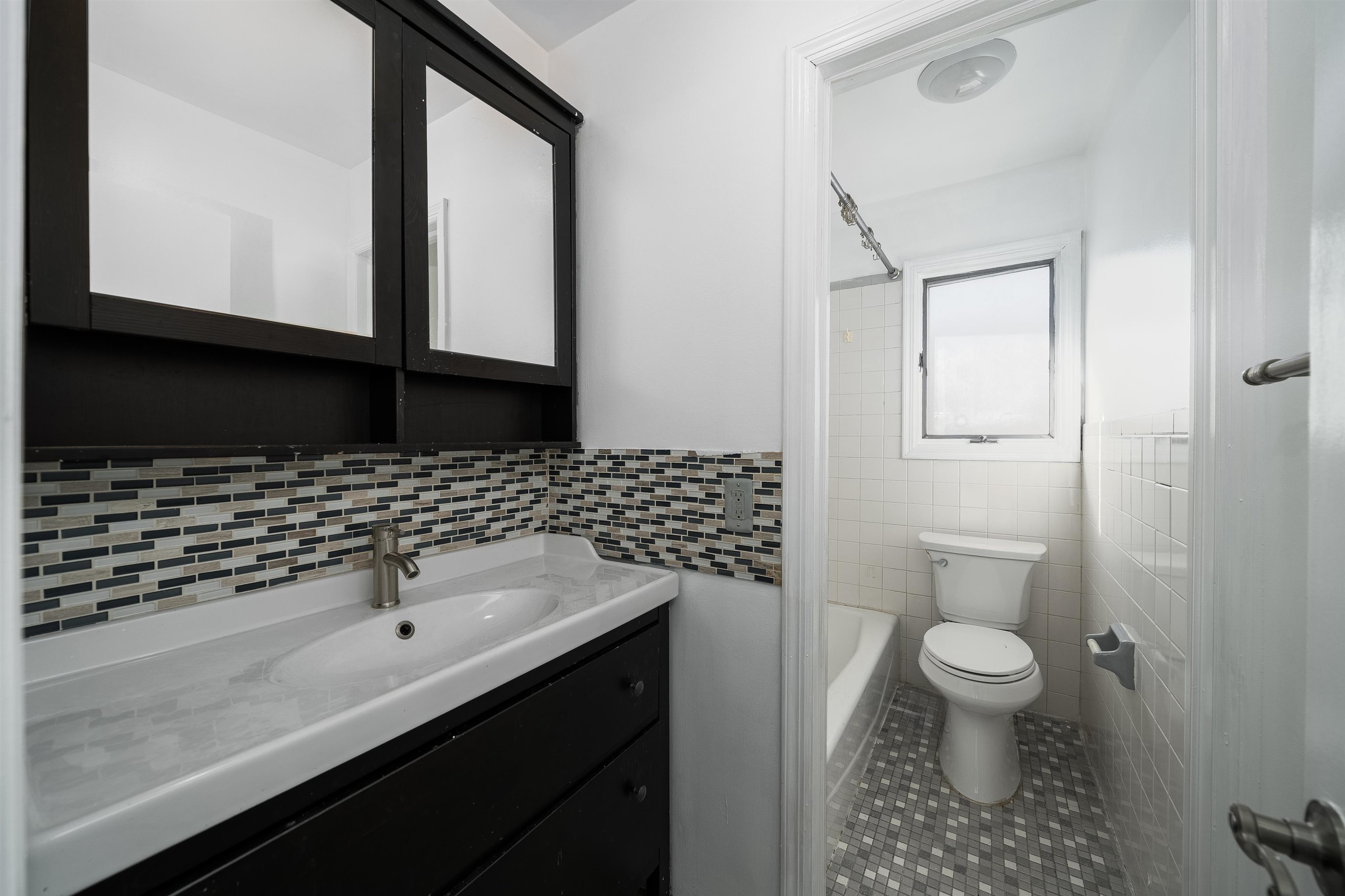 156 Main Street East Rutherford, NJ 07073 - Photo 15 of 19 a bathroom with a sink a toilet and shower