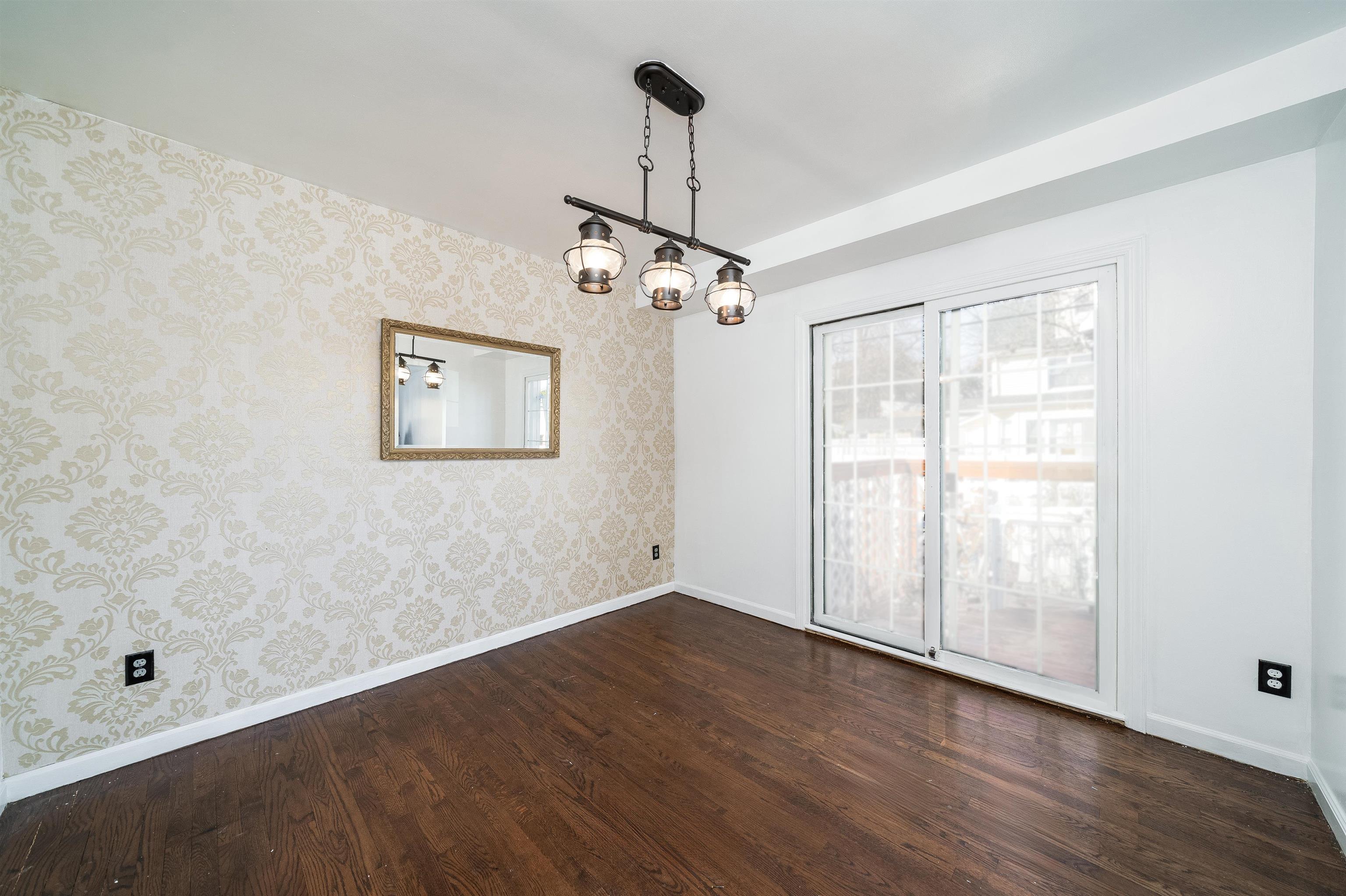 156 Main Street East Rutherford, NJ 07073 - Photo 7 of 19 wooden floor in an empty room with a window