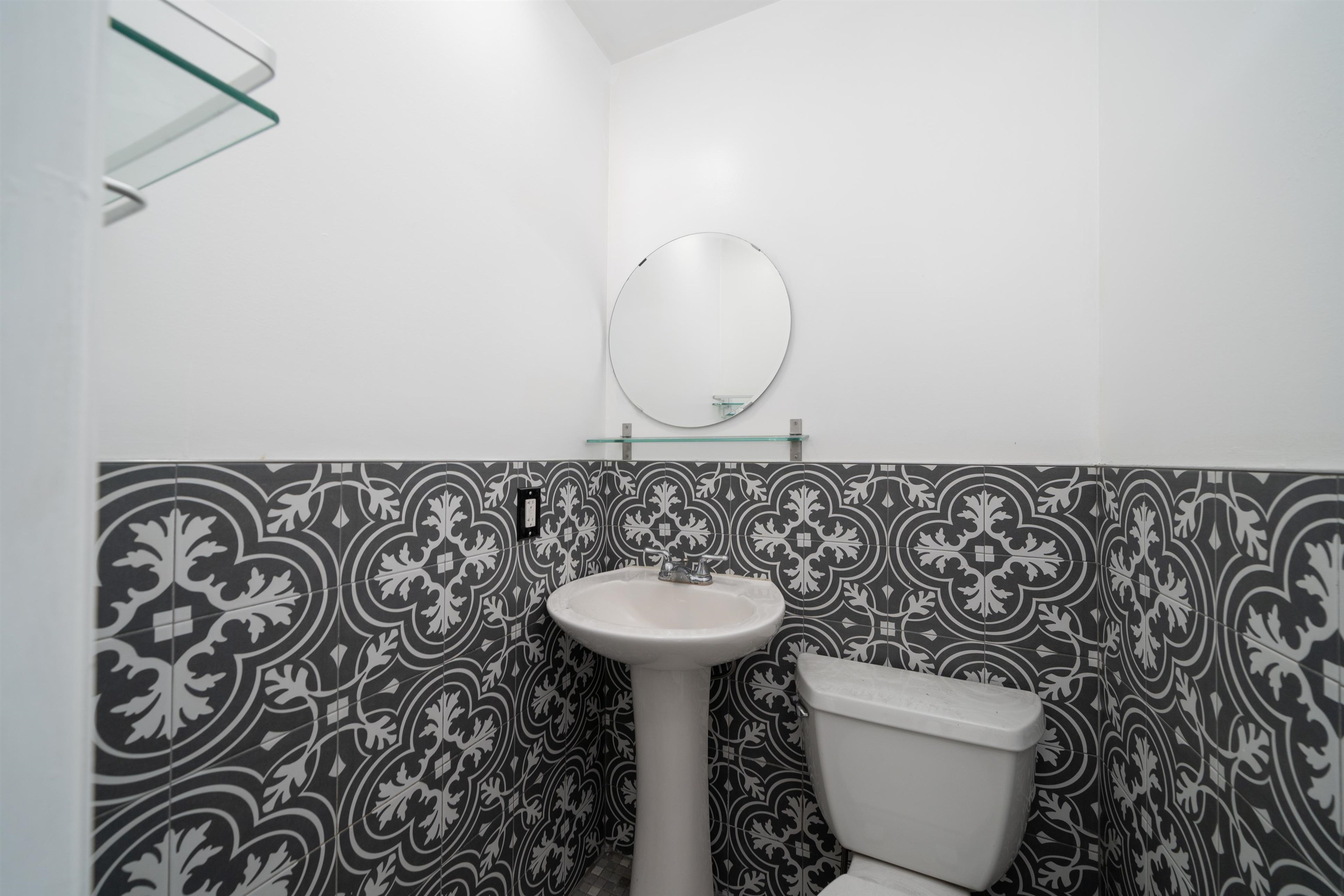 156 Main Street East Rutherford, NJ 07073 - Photo 10 of 19 a bathroom with a toilet sink and mirror