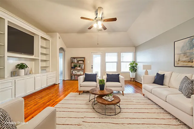 a living room with furniture a rug and a chandelier