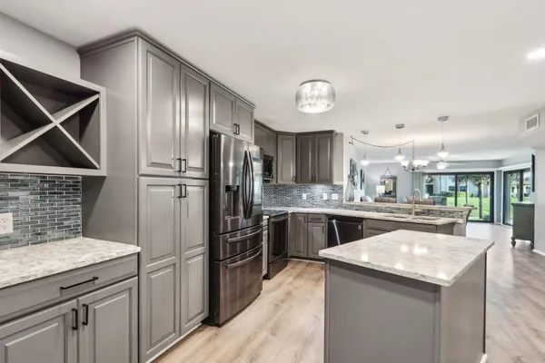 a kitchen with refrigerator and cabinets