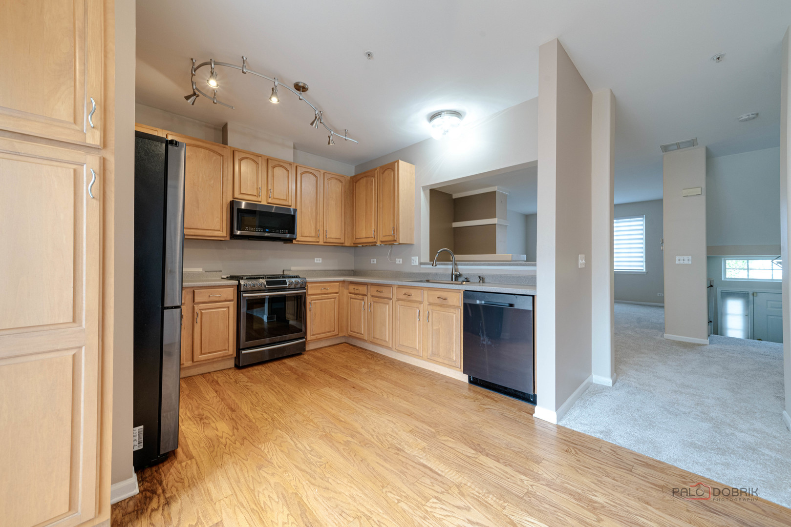1719 Sienna Court Wheeling, IL 60090 - Photo 15 of 34 a kitchen with a stove a sink and a microwave