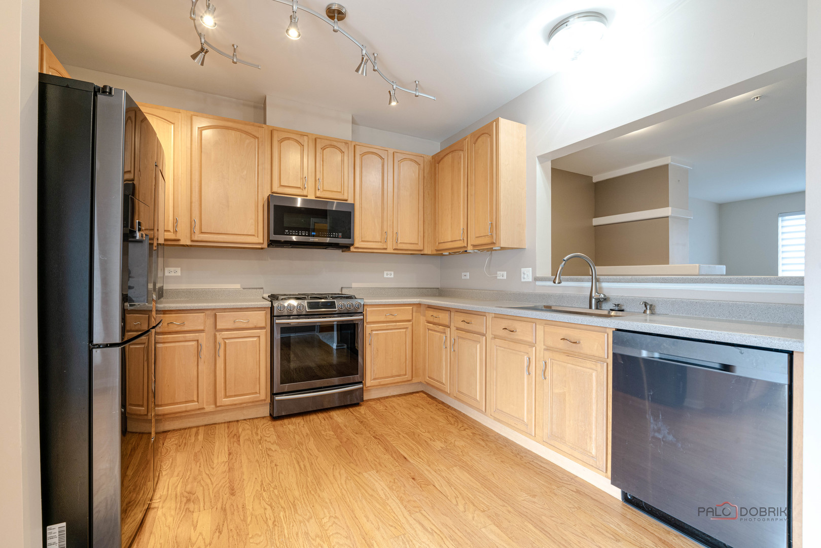 1719 Sienna Court Wheeling, IL 60090 - Photo 17 of 34 a kitchen with granite countertop a stove top oven sink and cabinets