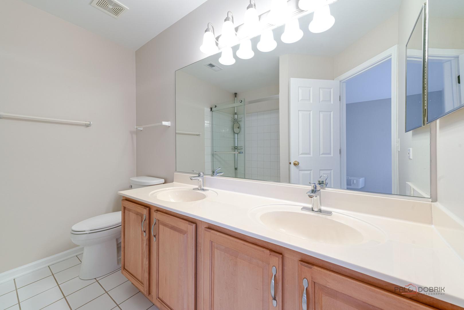 1719 Sienna Court Wheeling, IL 60090 - Photo 22 of 34 a bathroom with a sink a toilet and a mirror