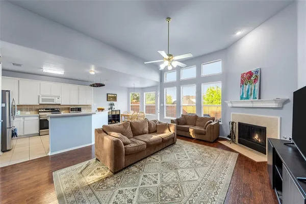 a living room with furniture fireplace and flat screen tv