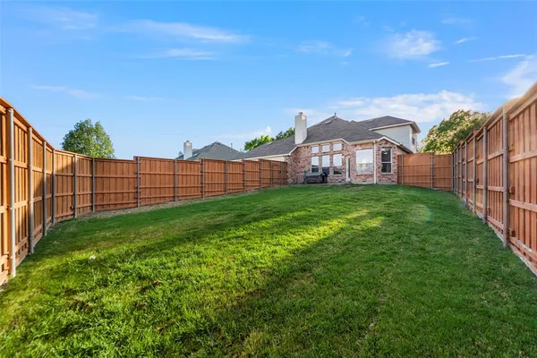 a view of a garden with a building in the background
