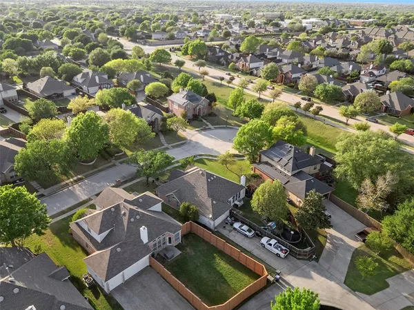 an aerial view of residential houses with outdoor space