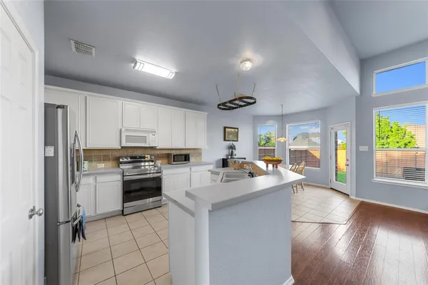 a large white kitchen with a large window