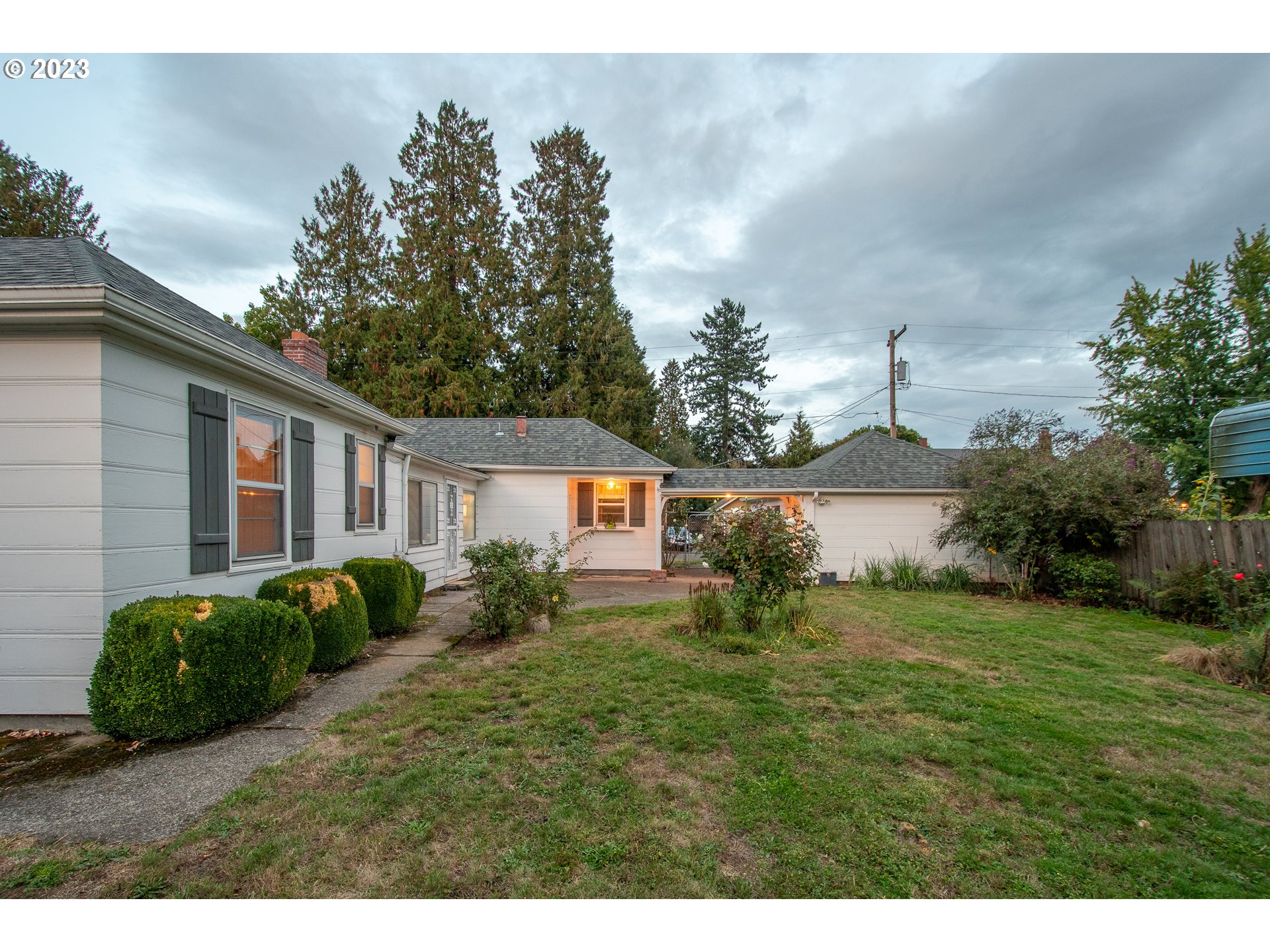110 Northwest 12th Street Gresham, OR 97030 - Photo 39 of 43 a backyard of a house with potted plants and large tree