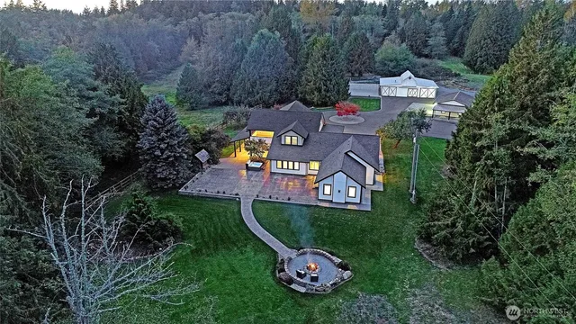 an aerial view of a house with garden space and street view