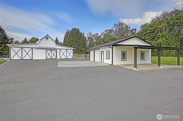 front view of a house with a yard and potted plants