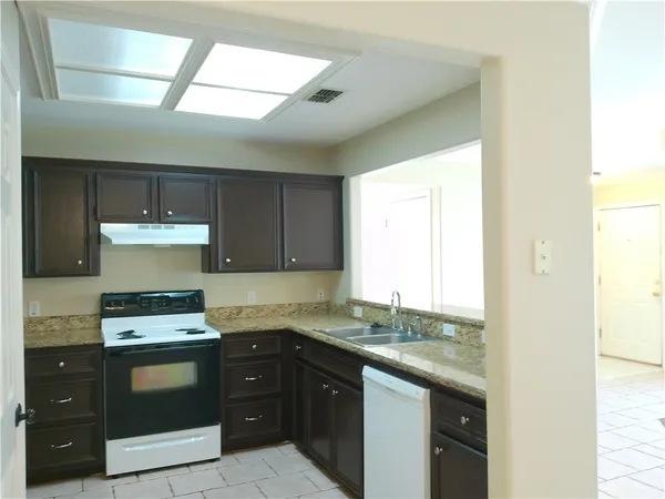 a kitchen with a stove and a sink