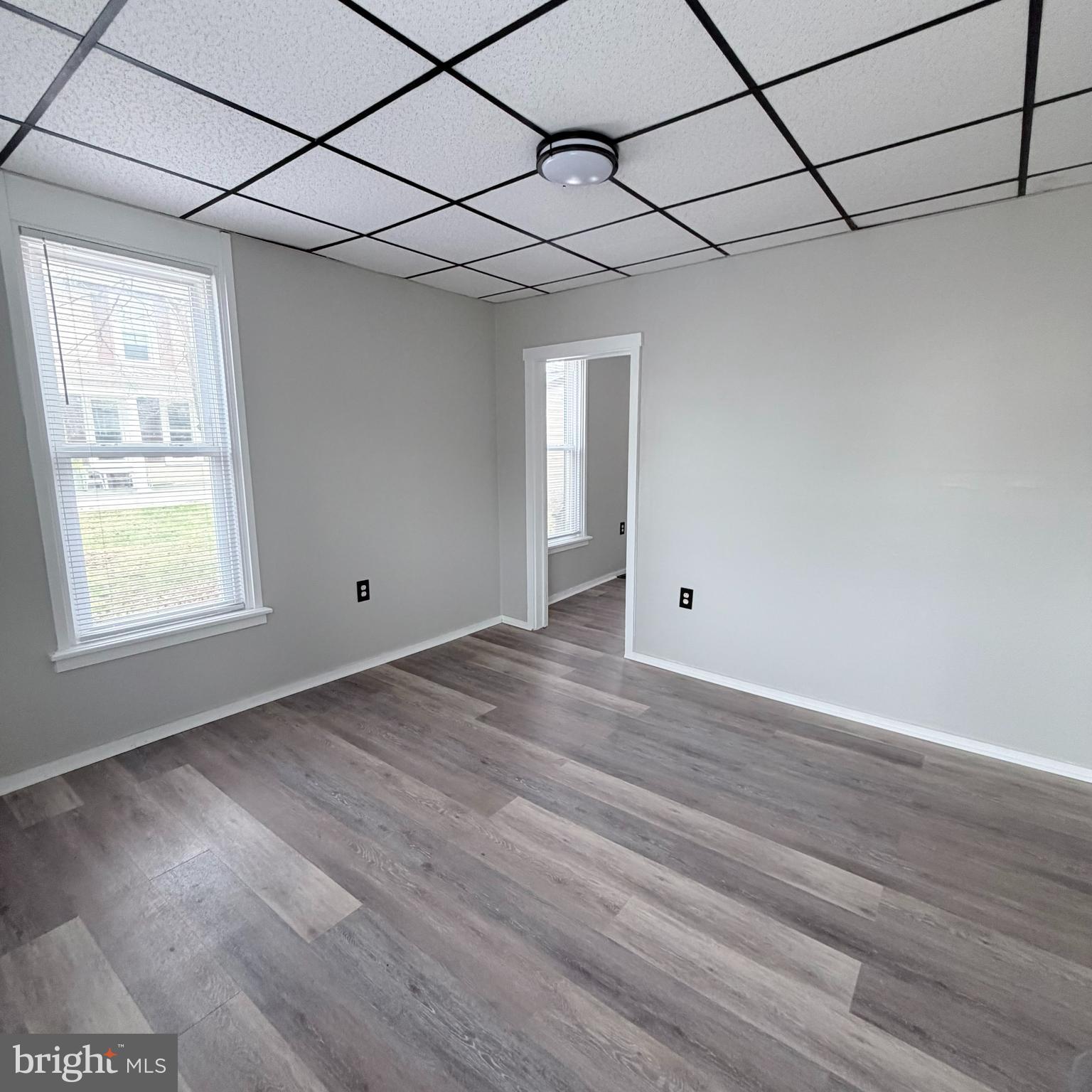 980 Scotland Avenue, Unit DOWNSTAIRS Chambersburg, PA 17201 - Photo 3 of 12 a view of a room with wooden floor and windows