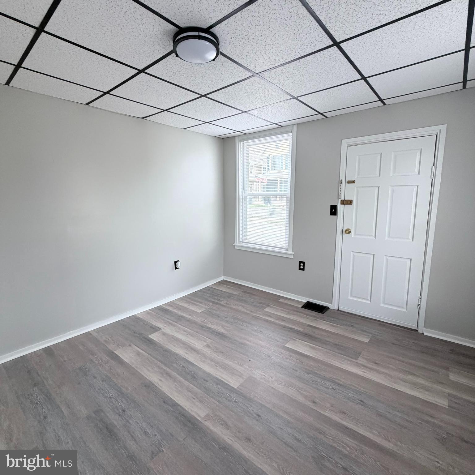 980 Scotland Avenue, Unit DOWNSTAIRS Chambersburg, PA 17201 - Photo 4 of 12 a view of an empty room with wooden floor and a window