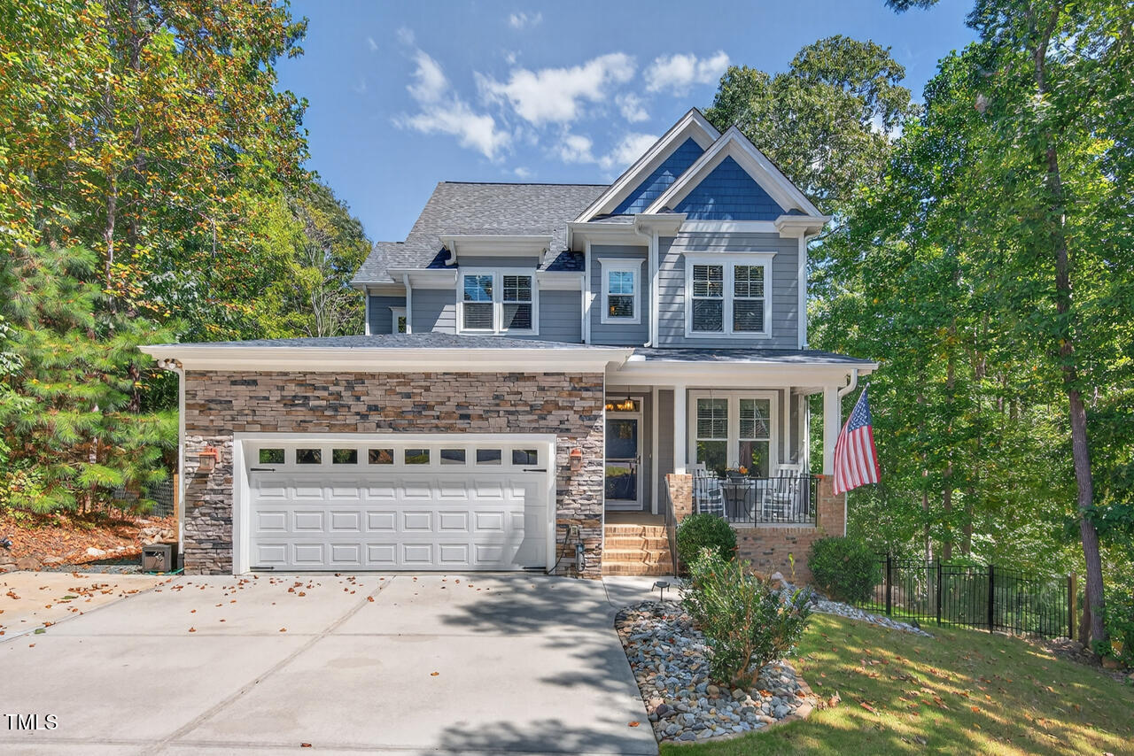 67 Ada Court Pittsboro, NC 27312 - Photo 1 of 63 a front view of a house with a garden and trees