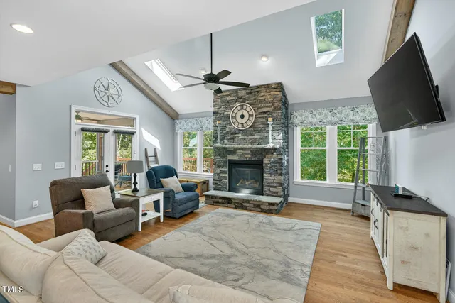 a living room with furniture a fireplace and a flat screen tv