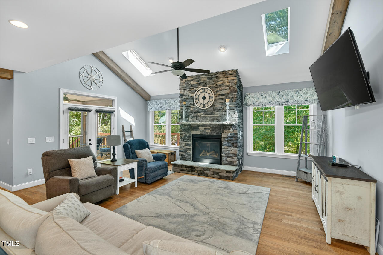 67 Ada Court Pittsboro, NC 27312 - Photo 12 of 63 a living room with furniture a flat screen tv and a fireplace