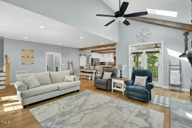 a living room with furniture fireplace and a large window