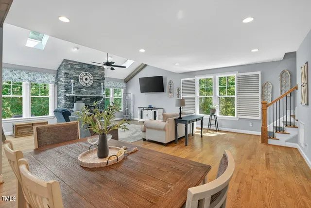 a kitchen with a table chairs refrigerator and cabinets