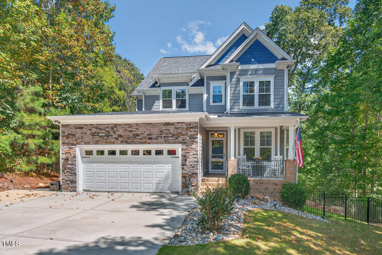 67 Ada Court Pittsboro, NC 27312 - Photo 2 of 63 a front view of a house with a yard and garage