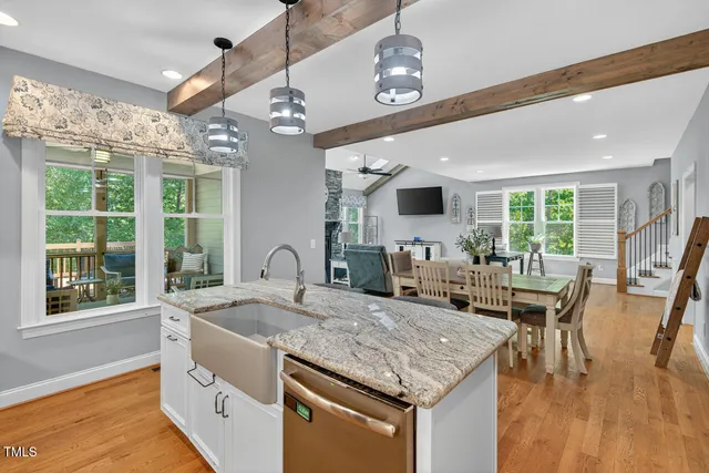 a kitchen with stainless steel appliances granite countertop a sink a stove and a refrigerator