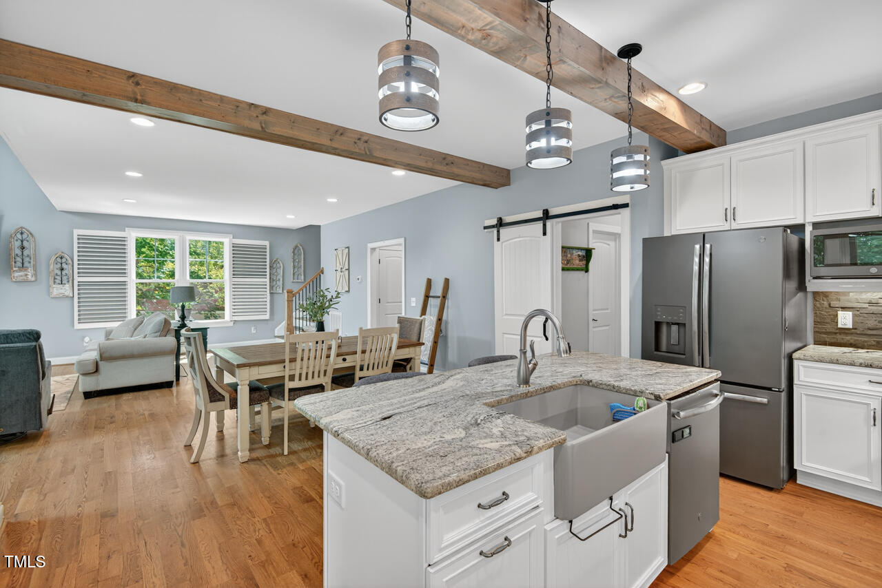 67 Ada Court Pittsboro, NC 27312 - Photo 24 of 63 a kitchen with stainless steel appliances granite countertop a sink a stove and a refrigerator