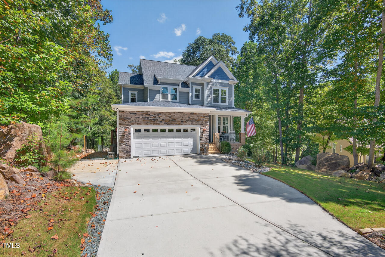 67 Ada Court Pittsboro, NC 27312 - Photo 3 of 63 a front view of a house with a yard and garage
