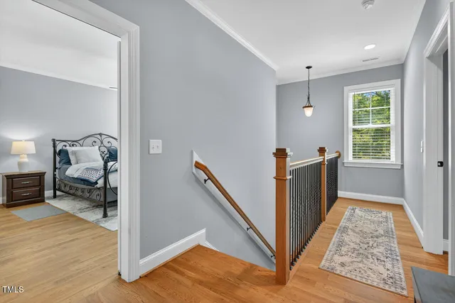 a spacious bedroom with a bed and a flat screen tv