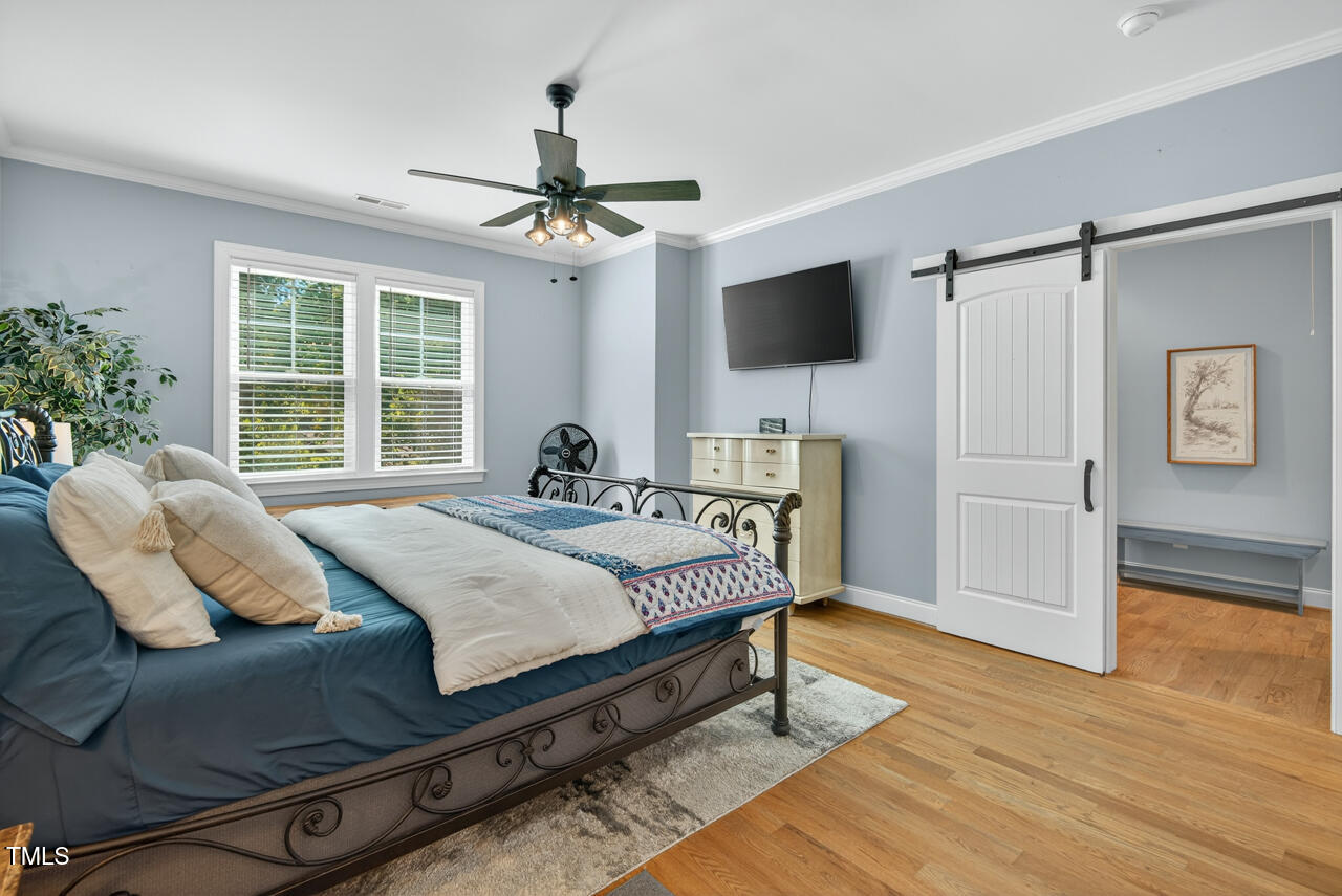 67 Ada Court Pittsboro, NC 27312 - Photo 33 of 63 a spacious bedroom with a bed and a flat screen tv