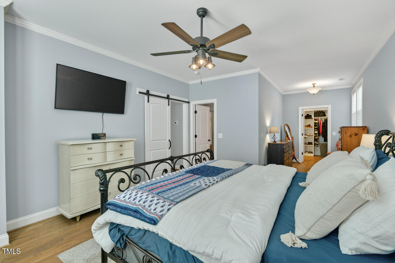 67 Ada Court Pittsboro, NC 27312 - Photo 35 of 63 a bedroom with a bed and a flat screen tv