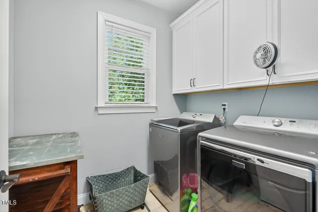 a bathroom with a sink double vanity granite tub shower and a mirror