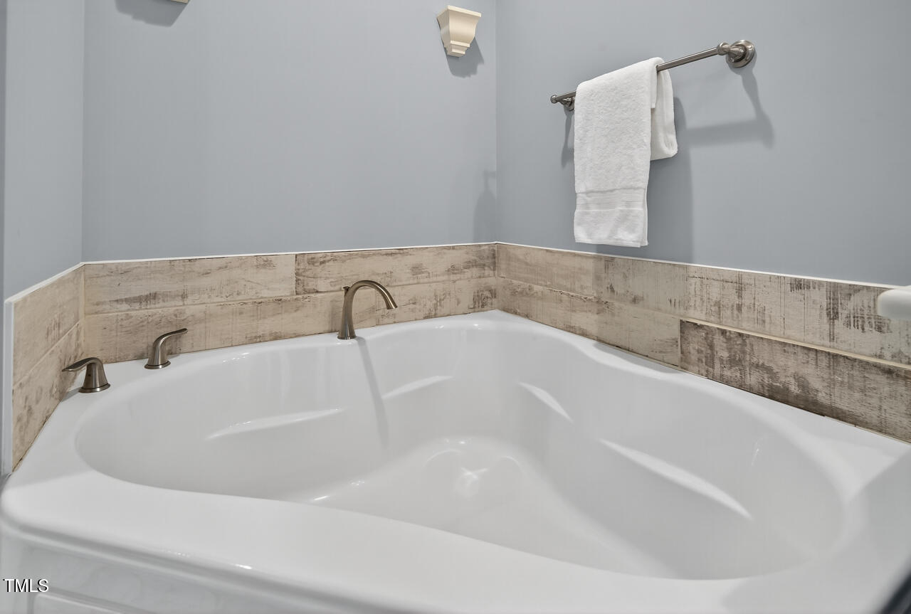 67 Ada Court Pittsboro, NC 27312 - Photo 44 of 63 a white bath tub sitting in a bathroom