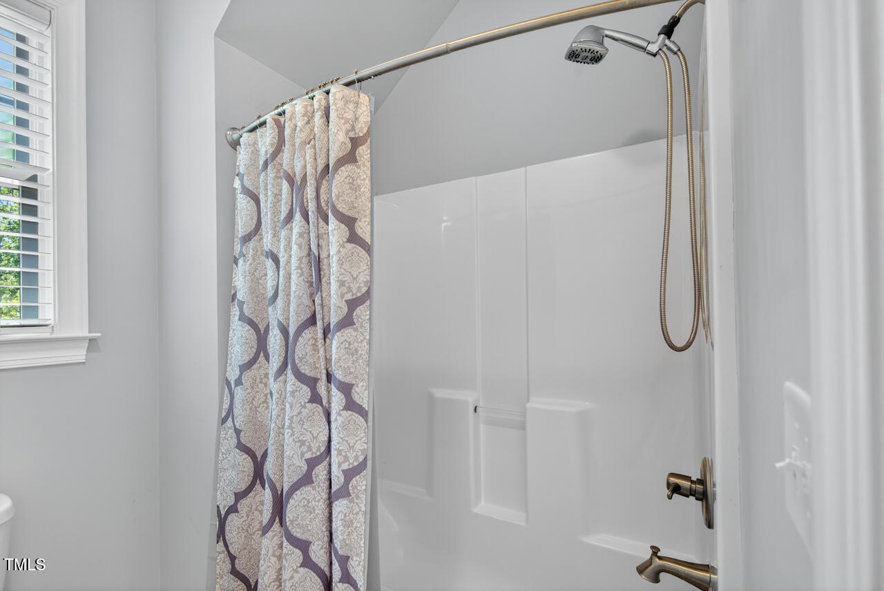 67 Ada Court Pittsboro, NC 27312 - Photo 49 of 63 a bathroom with a shower curtain and a shower curtain
