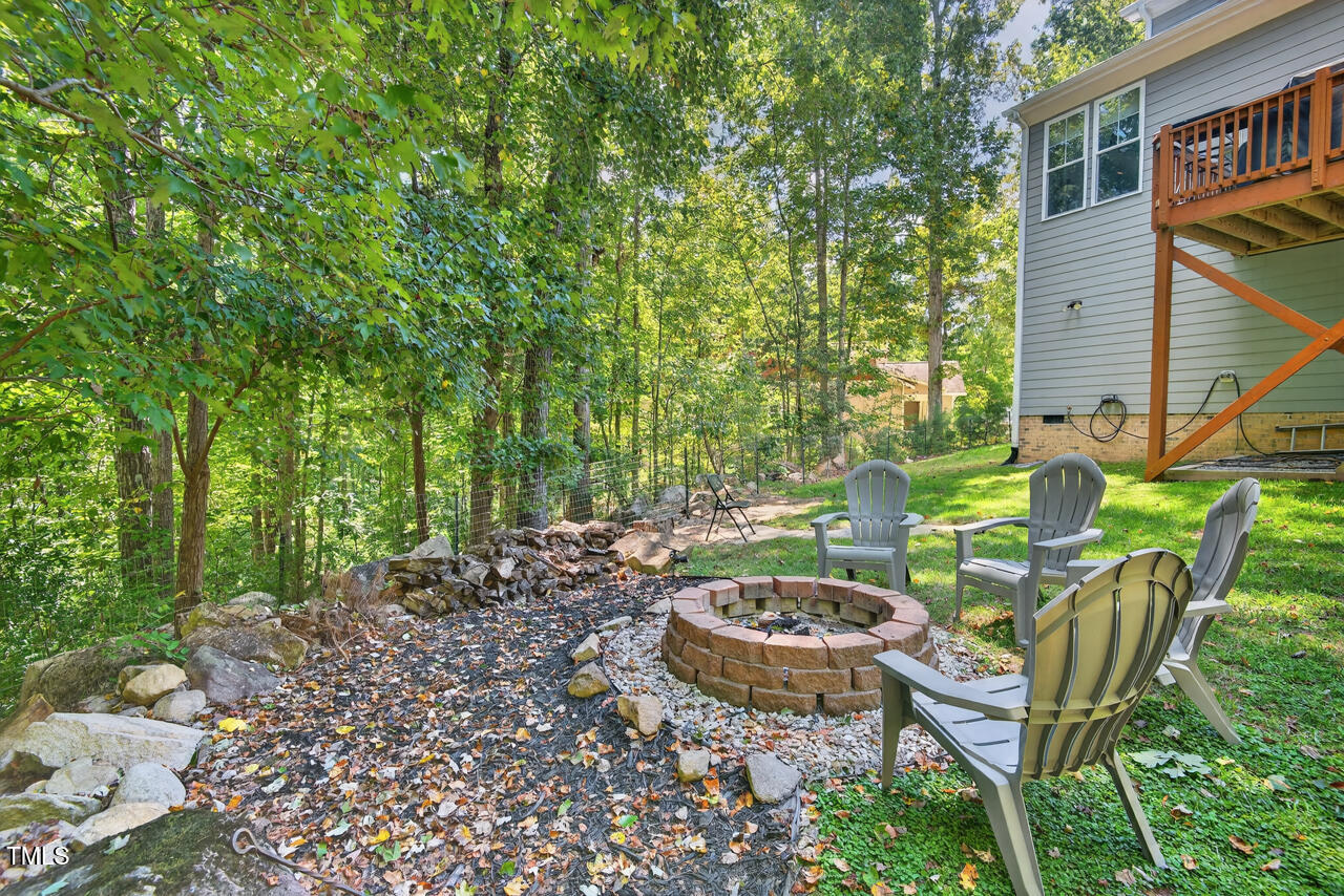 67 Ada Court Pittsboro, NC 27312 - Photo 56 of 63 a view of a backyard with table and chairs and potted plants