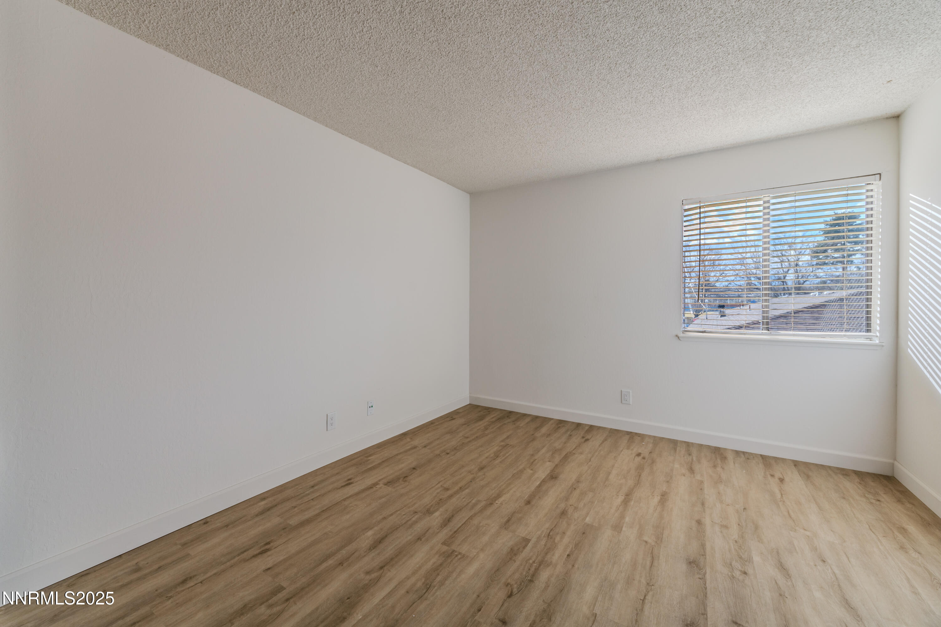 1000 Beck Drive, Unit 276 Reno, NV 89509 - Photo 7 of 10 an empty room with wooden floor and windows