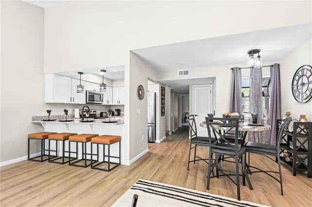 a dining room with furniture and wooden floor