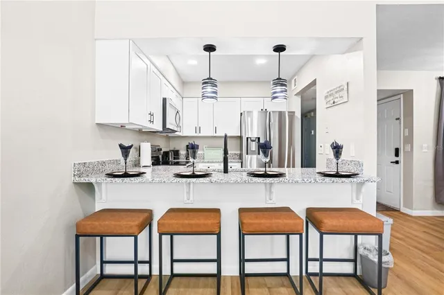 a kitchen with sink and chairs