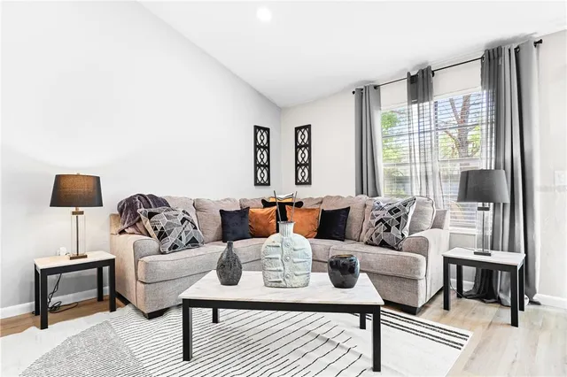 a living room with furniture and a lamp